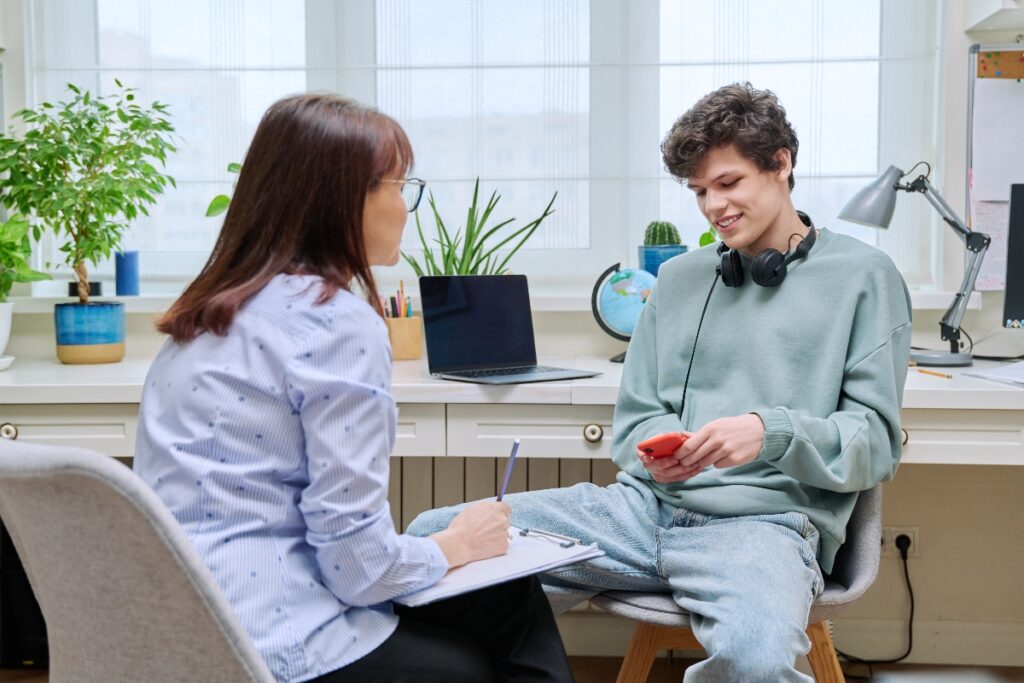 teen boy speaking with therapist about drug addiction problem