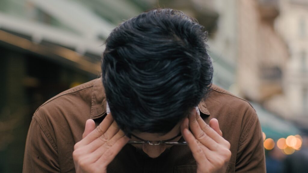man frustrated with head in his hands