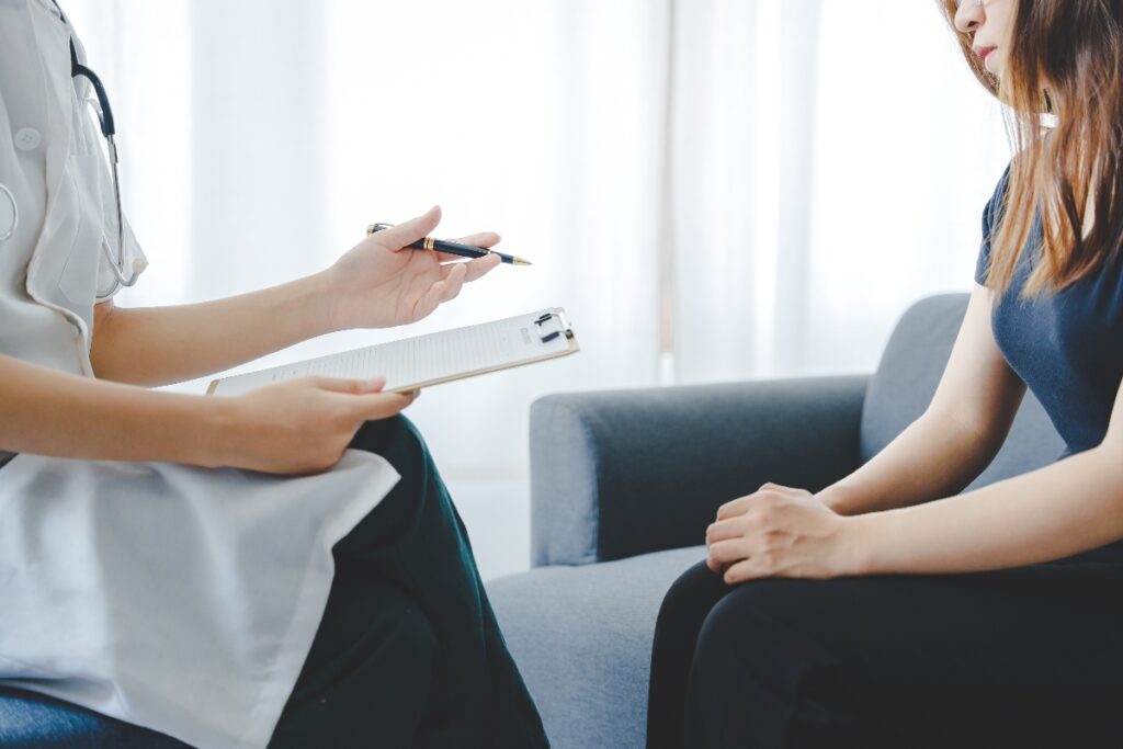 therapist with notepad meeting with anxious client