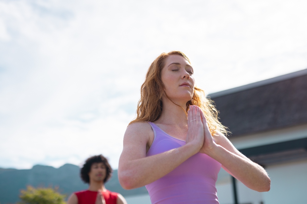 woman doing yoga outside - yoga therapy in los angeles