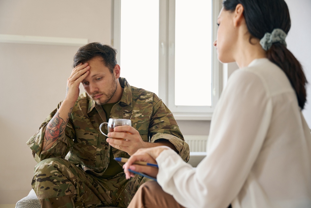 man in military uniform meeting with a therapist for PTSD