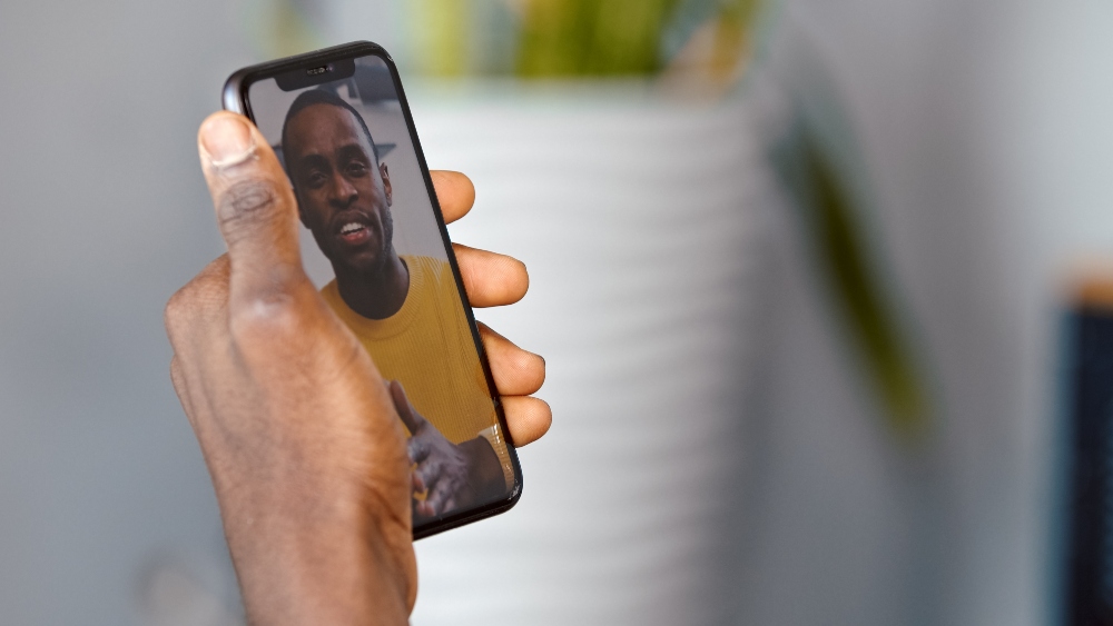 man speaking to therapist on the phone in california
