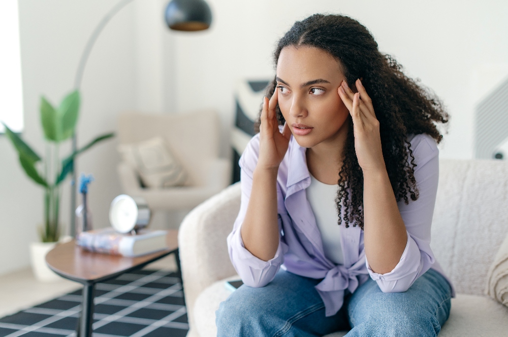 woman sitting in chair affected by traumatic memories