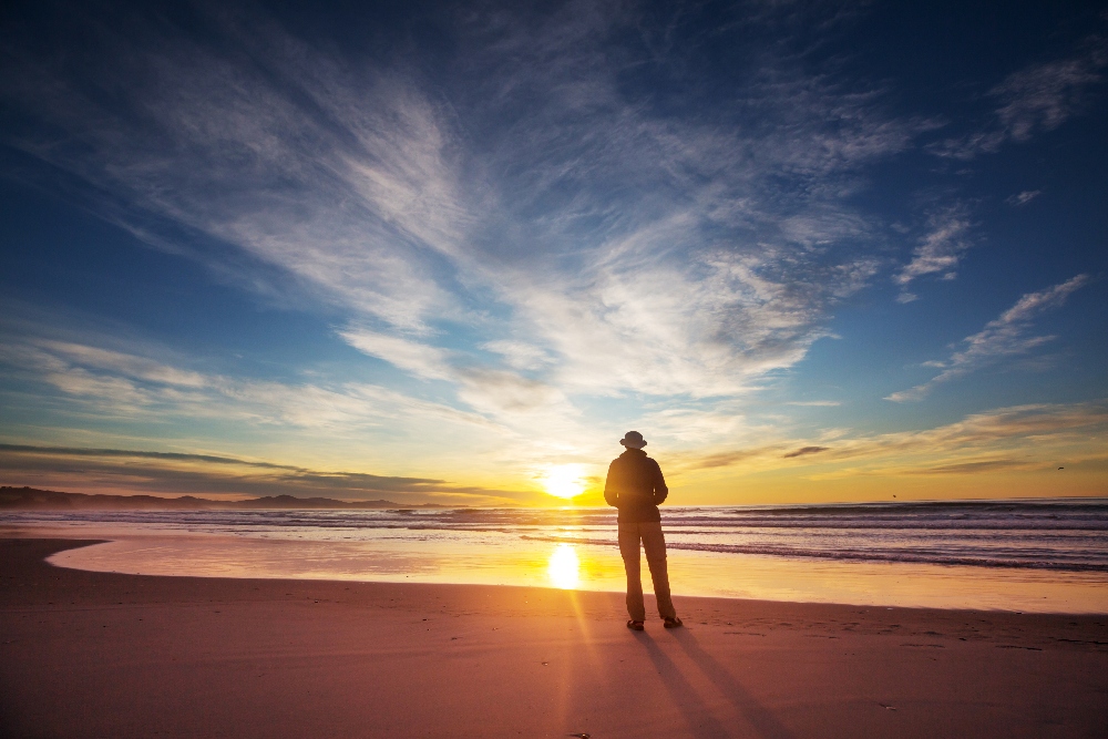 man in recovery looking at sunset